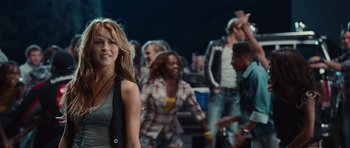 Movie still from “Footloose” (2011), directed by Craig Brewer – A group of people standing in a room; Medium shot, Over the shoulder angle