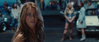 Movie still from “Footloose” (2011), directed by Craig Brewer – A woman standing on the side of the street; Close Up shot, Over the shoulder angle