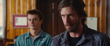 Movie still from “Footloose” (2011), directed by Craig Brewer – Two men are standing in a room looking at the camera; Close Up shot, Over the shoulder angle