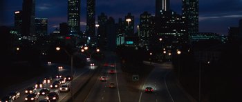 Movie still from “Footloose” (2011), directed by Craig Brewer – Cars driving down a city street at night; Extreme Wide shot, High angle