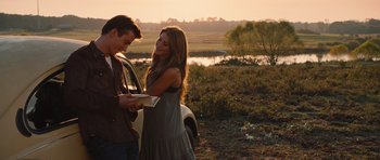 Movie still from “Footloose” (2011), directed by Craig Brewer – A man and a woman standing next to each other in a field; Medium shot, Over the shoulder angle