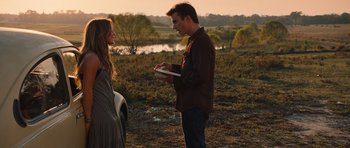 Movie still from “Footloose” (2011), directed by Craig Brewer – A man and a woman standing next to each other in a field; Medium shot, Over the shoulder angle