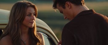 Movie still from “Footloose” (2011), directed by Craig Brewer – A man and a woman standing next to each other in front of a car; Close Up shot, Over the shoulder angle