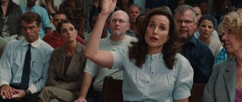 Movie still from “Footloose” (2011), directed by Craig Brewer – A woman raises her hand in front of a group of people; Medium shot, Over the shoulder angle