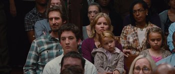 Movie still from “Footloose” (2011), directed by Craig Brewer – A group of people sitting and standing in a room; Medium shot, Over the shoulder angle
