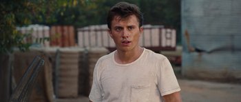 Movie still from “Footloose” (2011), directed by Craig Brewer – A man in a white t - shirt is looking at the camera; Close Up shot, Low angle