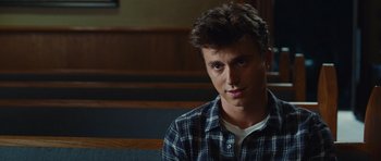 Movie still from “Footloose” (2011), directed by Craig Brewer – A man sitting on a bench looking at the camera; Close Up shot, Over the shoulder angle