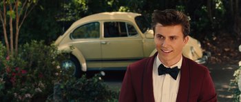 Movie still from “Footloose” (2011), directed by Craig Brewer – A man in a suit and bow tie standing in front of an old car; Close Up shot, Over the shoulder angle