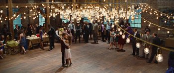 Movie still from “Footloose” (2011), directed by Craig Brewer – A group of people standing in a room with lights hanging from the ceiling; Wide shot, High angle