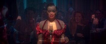 Movie still from “The United States vs. Billie Holiday” (2021), directed by Lee Daniels – A woman in a red dress singing into a microphone; Close Up shot, Over the shoulder angle