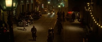 Movie still from “The United States vs. Billie Holiday” (2021), directed by Lee Daniels – A group of people walking down a street at night; Extreme Wide shot, High angle