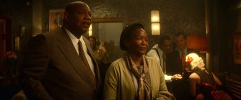 Movie still from “The United States vs. Billie Holiday” (2021), directed by Lee Daniels – A man and a woman standing next to each other; Medium shot, Low angle