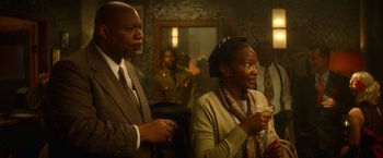 Movie still from “The United States vs. Billie Holiday” (2021), directed by Lee Daniels – A man and a woman are standing in a room; Medium shot, Over the shoulder angle