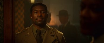 Movie still from “The United States vs. Billie Holiday” (2021), directed by Lee Daniels – A man in a military uniform and a hat; Close Up shot, Over the shoulder angle