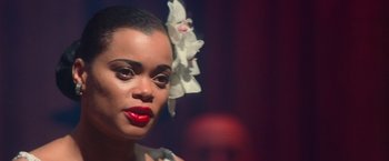 Movie still from “The United States vs. Billie Holiday” (2021), directed by Lee Daniels – A person with a flower in her hair; Close Up shot, Over the shoulder angle