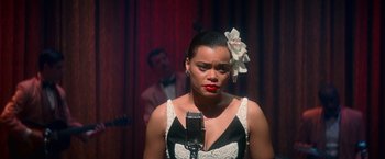 Movie still from “The United States vs. Billie Holiday” (2021), directed by Lee Daniels – A woman in a black and white dress with a flower in her hair; Close Up shot, Over the shoulder angle