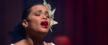Movie still from “The United States vs. Billie Holiday” (2021), directed by Lee Daniels – A person with a flower in her hair; Close Up shot, High angle