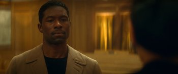 Movie still from “The United States vs. Billie Holiday” (2021), directed by Lee Daniels – A man in a jacket and a black t - shirt is in front of a window; Close Up shot, Over the shoulder angle