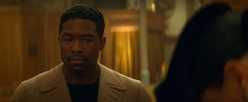 Movie still from “The United States vs. Billie Holiday” (2021), directed by Lee Daniels – A man in a suit looking at the camera; Close Up shot, Over the shoulder angle