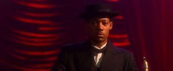 Movie still from “The United States vs. Billie Holiday” (2021), directed by Lee Daniels – A man wearing a suit and a top hat; Close Up shot, Low angle