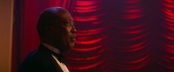 Movie still from “The United States vs. Billie Holiday” (2021), directed by Lee Daniels – A man in a tuxedo looking up at the ceiling; Close Up shot, Low angle