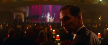 Movie still from “The United States vs. Billie Holiday” (2021), directed by Lee Daniels – A man in a suit and tie in front of an audience; Close Up shot, Over the shoulder angle