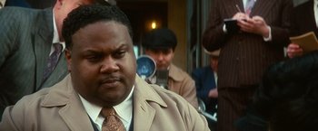 Movie still from “The United States vs. Billie Holiday” (2021), directed by Lee Daniels – A man that is wearing a suit and a tie; Close Up shot, Over the shoulder angle