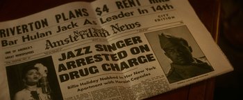 Movie still from “The United States vs. Billie Holiday” (2021), directed by Lee Daniels – An old newspaper with the headline " jazz singer arrested on drug charge "; Extreme Close Up shot, High angle