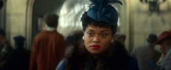 Movie still from “The United States vs. Billie Holiday” (2021), directed by Lee Daniels – A woman in a blue hat and a fur coat; Close Up shot, Over the shoulder angle