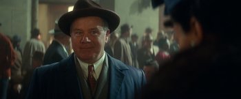 Movie still from “The United States vs. Billie Holiday” (2021), directed by Lee Daniels – A person wearing a suit and a hat; Close Up shot, Over the shoulder angle