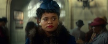 Movie still from “The United States vs. Billie Holiday” (2021), directed by Lee Daniels – A woman wearing a blue hat with a feather on it; Close Up shot, Over the shoulder angle