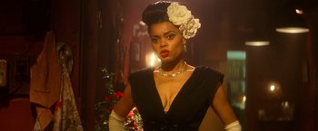 Movie still from “The United States vs. Billie Holiday” (2021), directed by Lee Daniels – A woman in a black dress with a flower in her hair; Close Up shot, Low angle