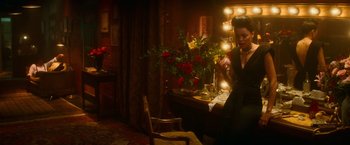 Movie still from “The United States vs. Billie Holiday” (2021), directed by Lee Daniels – A woman sitting in front of a mirror in a room; Wide shot, Over the shoulder angle