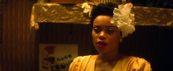 Movie still from “The United States vs. Billie Holiday” (2021), directed by Lee Daniels – A woman with a flower in her hair; Close Up shot, Over the shoulder angle