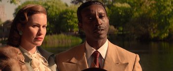 Movie still from “The United States vs. Billie Holiday” (2021), directed by Lee Daniels – A man wearing a suit and tie standing in front of a body of water; Close Up shot, Low angle