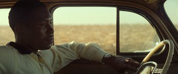 Movie still from “The United States vs. Billie Holiday” (2021), directed by Lee Daniels – A man sitting in a car looking out the window; Close Up shot, Over the shoulder angle
