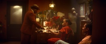 Movie still from “The United States vs. Billie Holiday” (2021), directed by Lee Daniels – A man and a woman sitting in front of a table; Medium shot, Over the shoulder angle