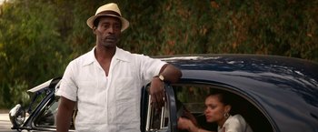 Movie still from “The United States vs. Billie Holiday” (2021), directed by Lee Daniels – A man and a woman sitting in the back of a car; Medium shot, Low angle