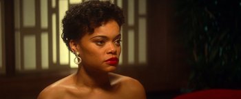 Movie still from “The United States vs. Billie Holiday” (2021), directed by Lee Daniels – A woman with red lipstick looking at the camera; Close Up shot, Over the shoulder angle