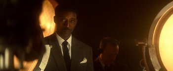 Movie still from “The United States vs. Billie Holiday” (2021), directed by Lee Daniels – A man in a suit and tie standing next to another man in a suit and tie; Close Up shot, Low angle