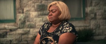 Movie still from “The United States vs. Billie Holiday” (2021), directed by Lee Daniels – A person sitting down holding a mirror; Close Up shot, High angle