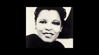 Movie still from “The United States vs. Billie Holiday” (2021), directed by Lee Daniels – An old black and white photo of a woman smiling; Close Up shot, High angle