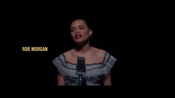 Movie still from “The United States vs. Billie Holiday” (2021), directed by Lee Daniels – A woman in a black and white dress is singing; Medium shot, Low angle