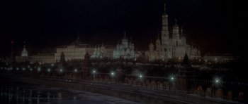 Movie still from “For Your Eyes Only” (1981), directed by John Glen – A view of a city at night from across a bridge; Extreme Wide shot, High angle