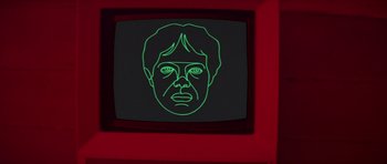 Movie still from “For Your Eyes Only” (1981), directed by John Glen – A neon green face on a television screen; Extreme Close Up shot, Overhead angle