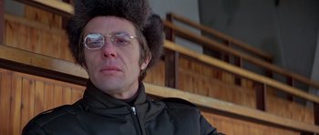 Movie still from “For Your Eyes Only” (1981), directed by John Glen – A man wearing a fur hat and sunglasses; Close Up shot, Low angle
