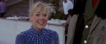 Movie still from “For Your Eyes Only” (1981), directed by John Glen – A woman with blonde hair and a blue top; Close Up shot, Low angle