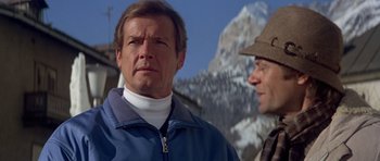 Movie still from “For Your Eyes Only” (1981), directed by John Glen – Two men standing next to each other in front of a snowy mountain; Close Up shot, Low angle