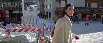 Movie still from “For Your Eyes Only” (1981), directed by John Glen – A woman walking in the snow next to construction cones; Medium shot, Low angle