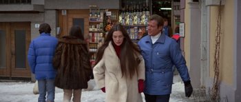 Movie still from “For Your Eyes Only” (1981), directed by John Glen – A man and a woman walking down a street; Medium shot, Over the shoulder angle